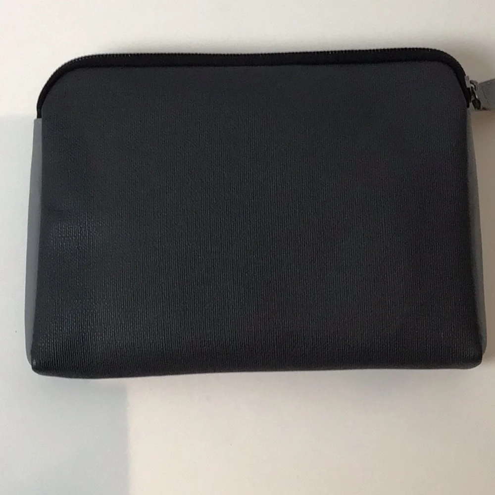 Almost complete Tumi amenities bag.